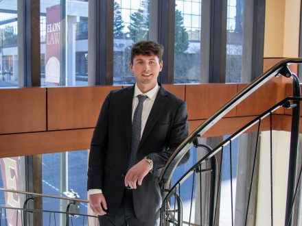 Frederick Hulse on a spiral staircase, brightly lit from windows overlooking the street.