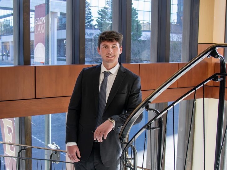 Frederick Hulse on a spiral staircase, brightly lit from windows overlooking the street.