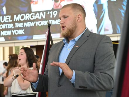 Elon football player Emerson Baker shares research in Snow Atrium.