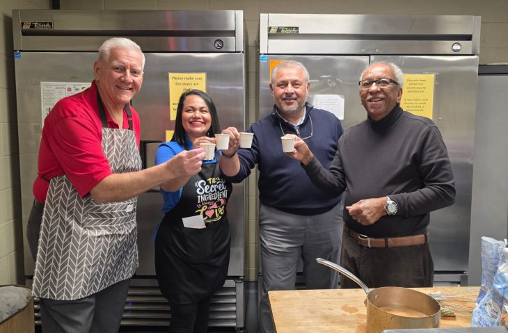 Elon Community Church pastor Randy Orwig and culinary storytellers Patty Holmes, Mohsin Sidiqui and Ervin Milton share a cup of chai while working during the Power+Place Collaborative Screening on Dec. 4 at the Elon Community Church.