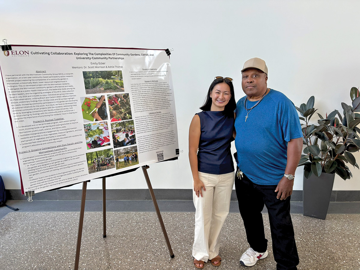 A student and community partner pose next to a research poster about collaboration between a university and a community garden.