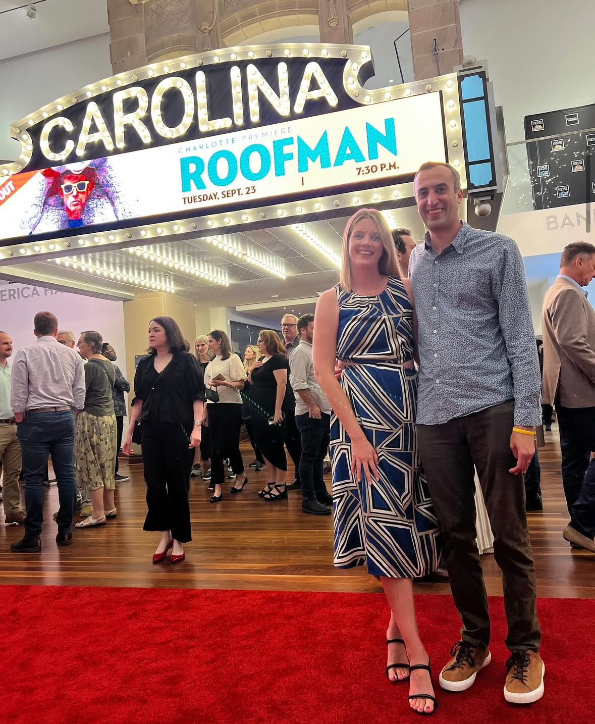 Joe Bruno '14 and his wife pose in front of signage for 'Roofman' | Photo courtesy of Joe Bruno