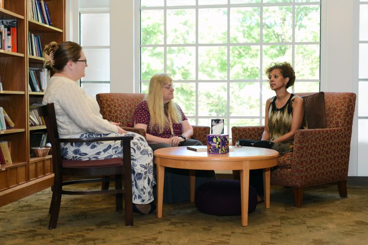 From left to right: the Rev. Julie Tonnesen, Catherine Little and Chekeitha Chambers meet in the Truitt Center library.