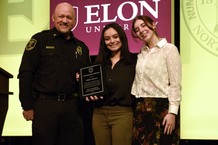 (Left to right) Elon University Chief of Campus Safety and Police Joe LeMire, Nikki Guevara '29 and Lucy Sharp. Guevara received a Lifesaving Award from Campus Safety and Police during Staff Update in Alumni Gym on Jan. 30, 2026 for her quick actions performing CPR on Sharp in September 2025.