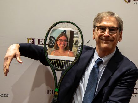 Elon professor Anthony Hatcher holds tennis racket