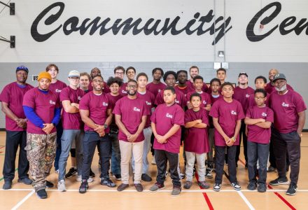 A group of people in pink shirts pose for a photo