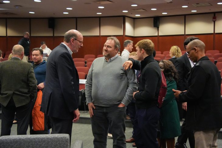 Jonathan Reckford in LaRose Digital Theatre speaking with a family after the event