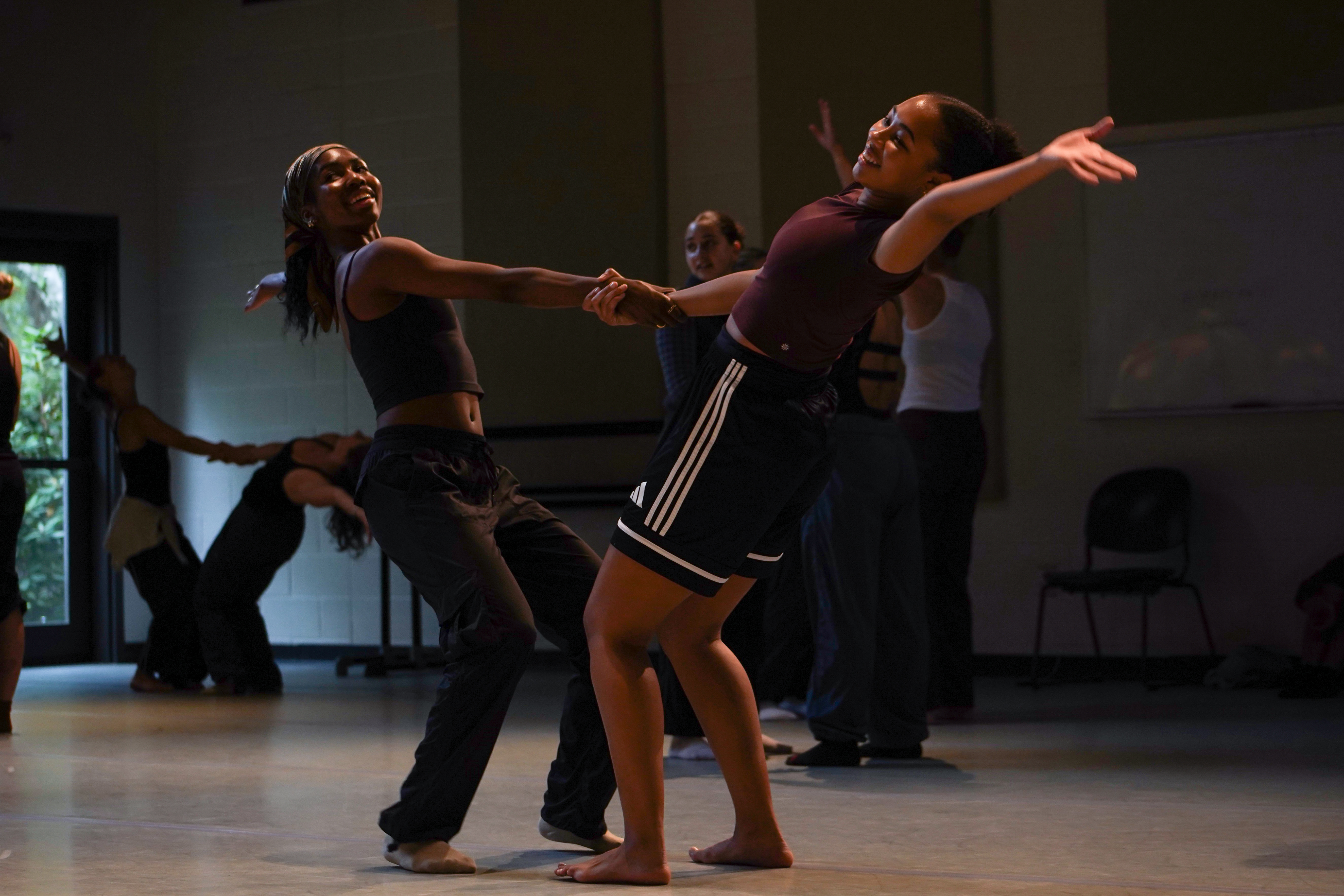 Two dancers holding hands for a dance