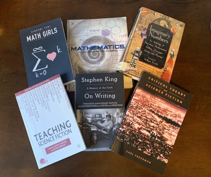 Six mathematical fiction book covers displayed on a table.