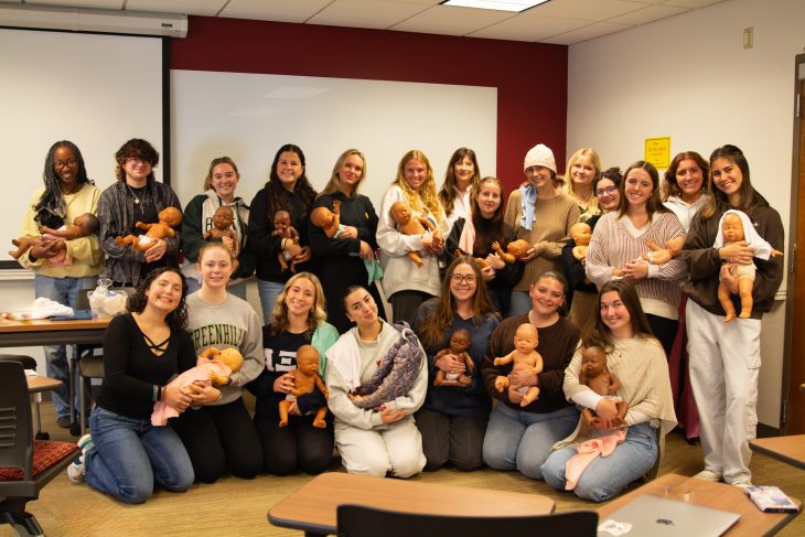 Cynthia Fair, professor of public health and human service studies and the Watts/Thompson Professor, with students in the Childbirth core seminar course.