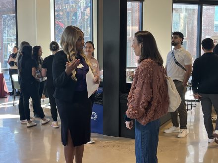 Two people talk in an office building