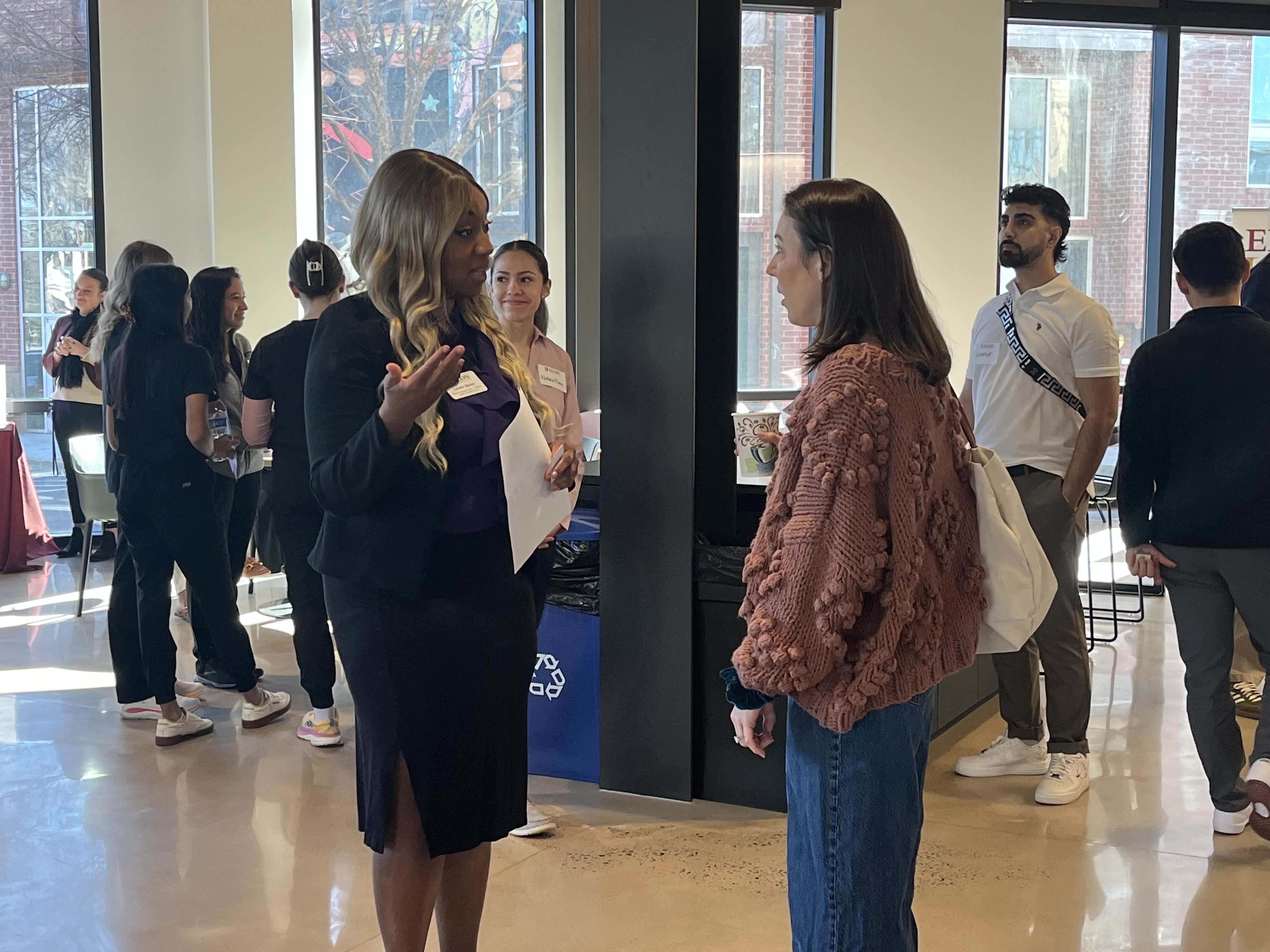 Two people talk in an office building