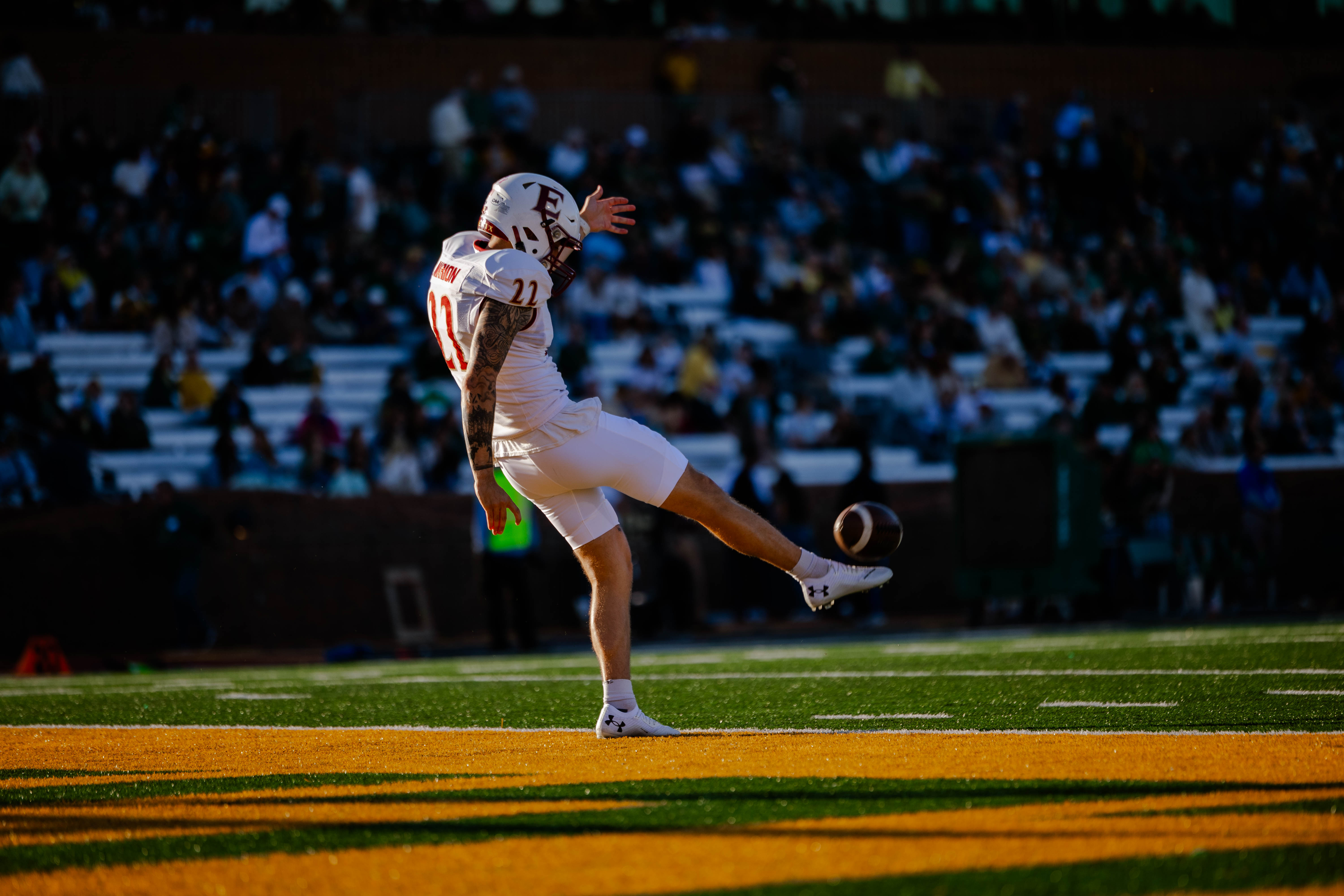 A football player kicks a ball
