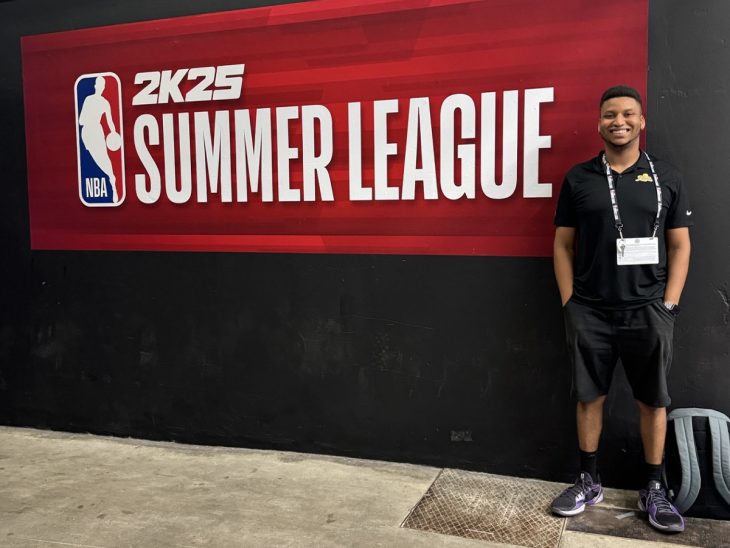 Emmanuel Tobe ’21 poses in front of the NBA Summer League Flag in LA