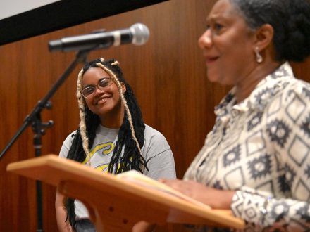 Jordan Young smiles as Professor Naeemah Clark