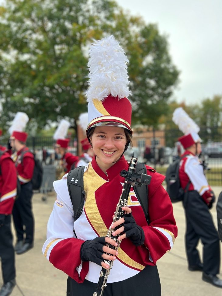 Karsyn Vann in her marching band uniform holding her clarinet