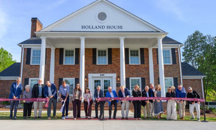 Members of the Board of Trustees, donors, and Elon University leaders including President Connie Ledoux Book and Director of Athletics Jenn Strawley cut the ribbon on April 10, 2026, during a rededication ceremony of the university's Holland House on South Campus.