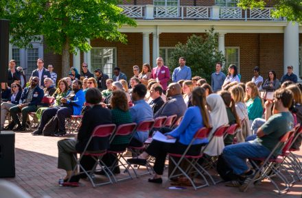 Faculty and staff sitting at a reception to celebrate three decades of International & Global Studies.