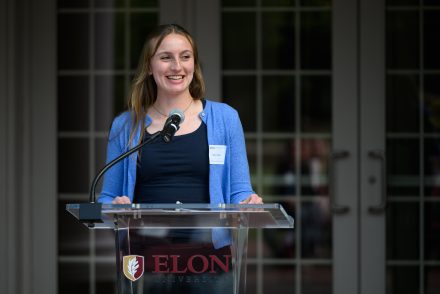 Nancy Mueller ’27 wearing a blue sweater giving remarks at the International & Global Studies event celebrating 30 years.