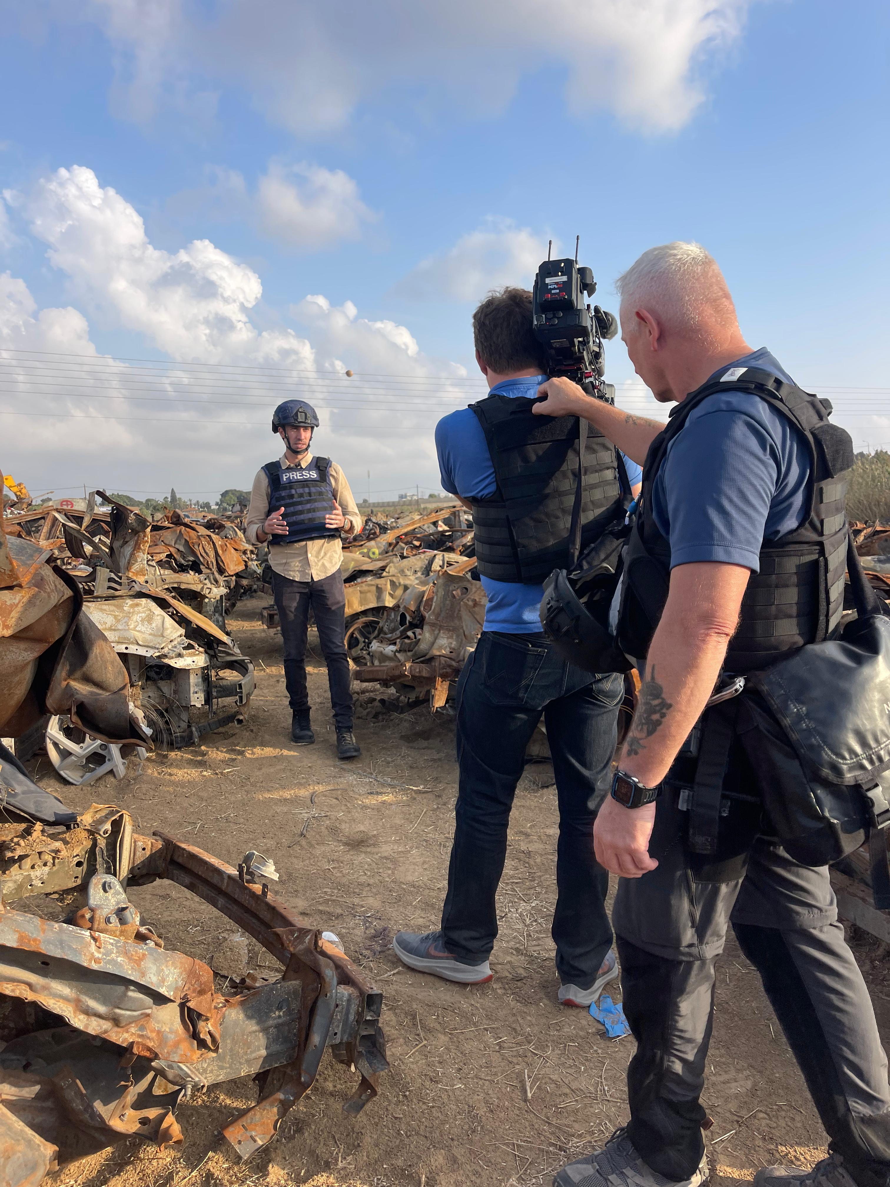 Doug Williams '13, seen reporting with protective gear in a war-torn Gaza.