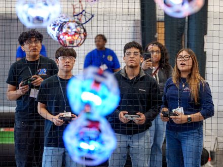 A group of students stand near a drone soccer arena net at ���ϲ�����.