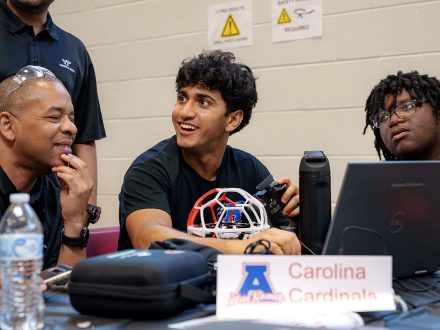 A male student competitor smiles while talking.