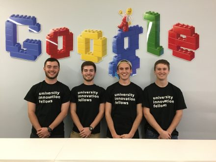 Jensen Roll '16 pictured smiling along with other university innovation fellows underneath a Google logo.