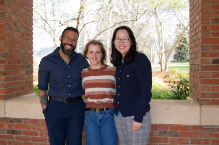 Efrain, Elise and Hwayeon standing together for a posed photo.