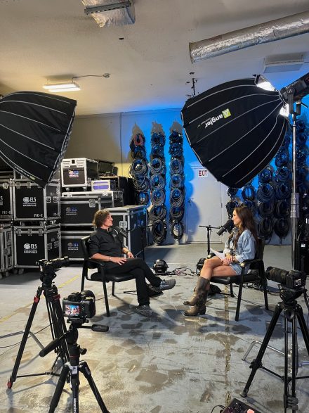 Nikki Sanz '18, pictured sitting down in a podcast studio.
