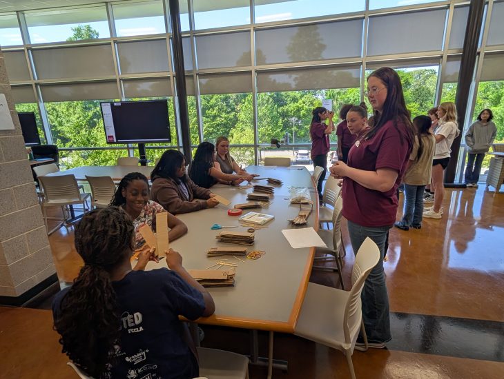 Students learning about how to build an arm model