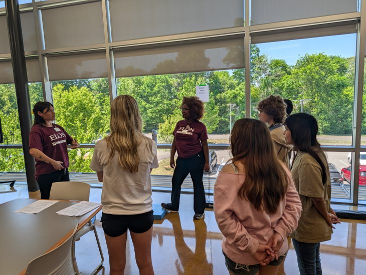 Students learning about balance in dance positions