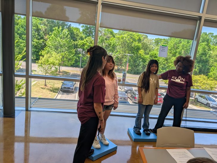 Students learning about balance at the Static Balance Station