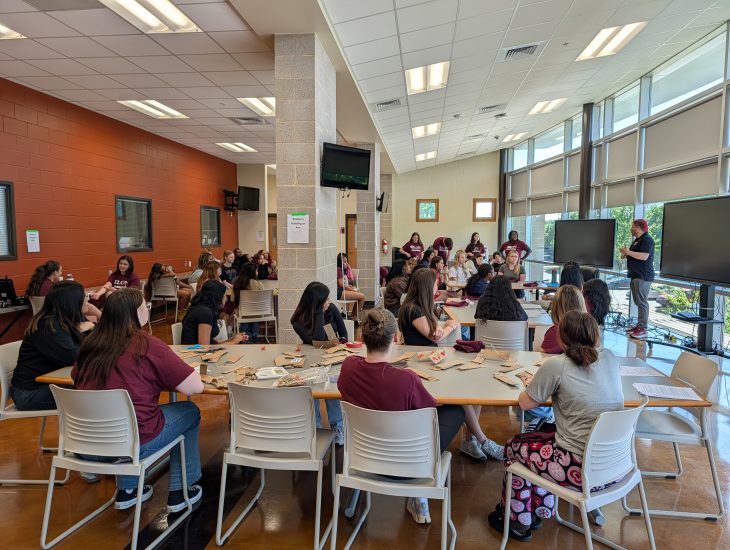Students sitting and listening to a speaker