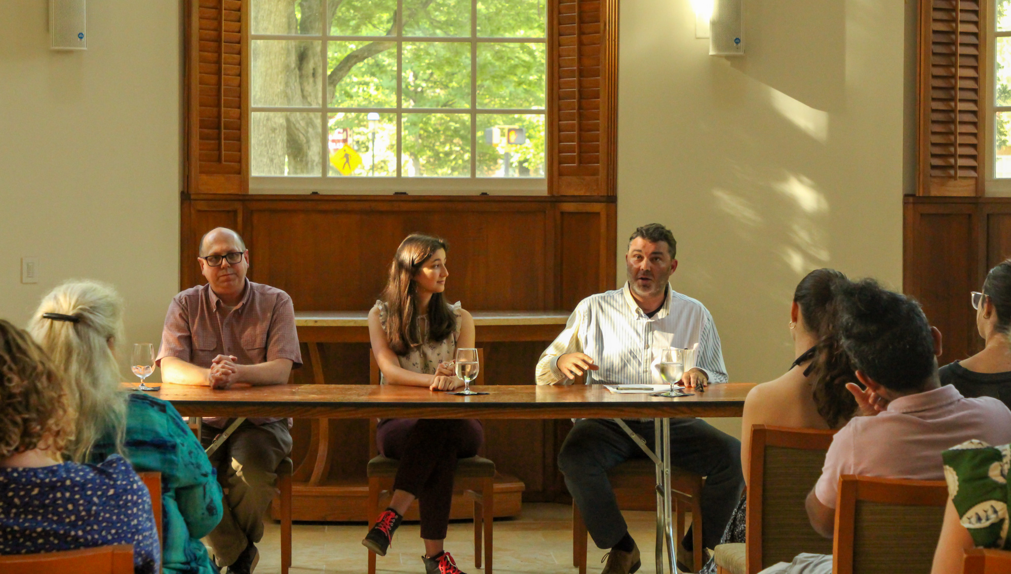 Three panelists sitting at a table.