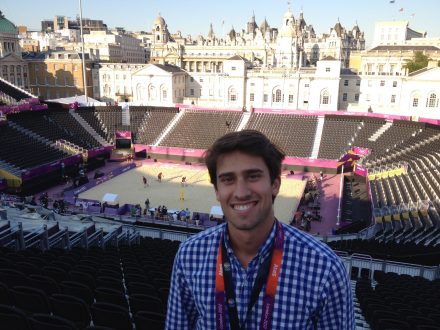 Doug Williams '13, smiles while in a beach volleyball arena in London as part of a summer internship for the 2012 Summer Olympics.