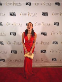 Helena Padial wearing a red dress and standing with her trophy at the Chita Rivera Awards on May 18.