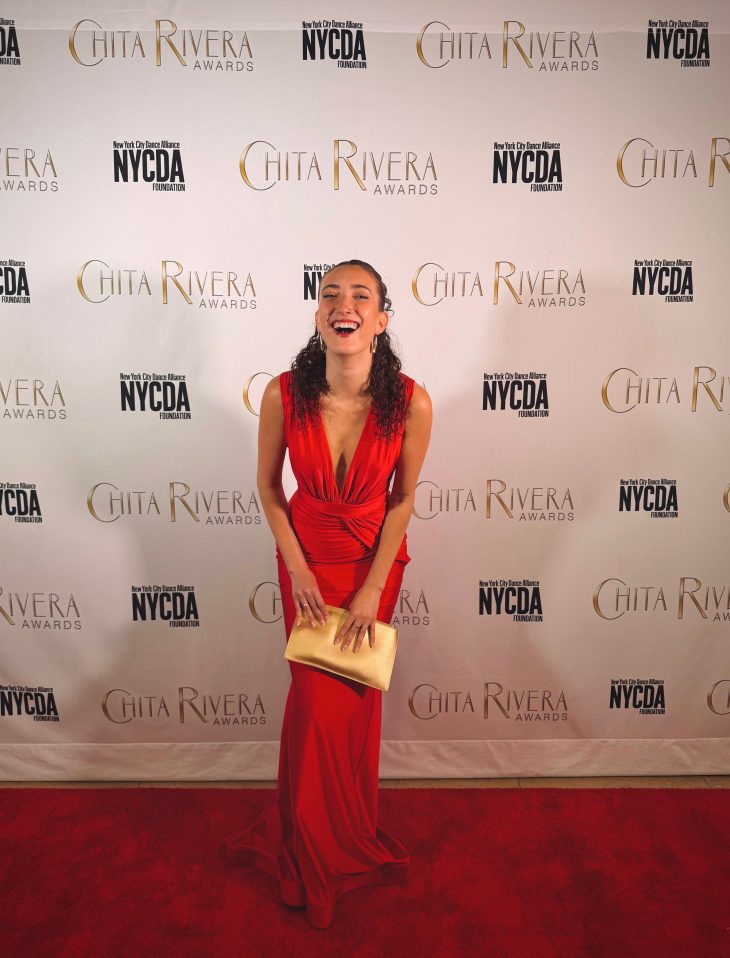 Helena Padial wearing a red dress and standing with her trophy at the Chita Rivera Awards on May 18. 