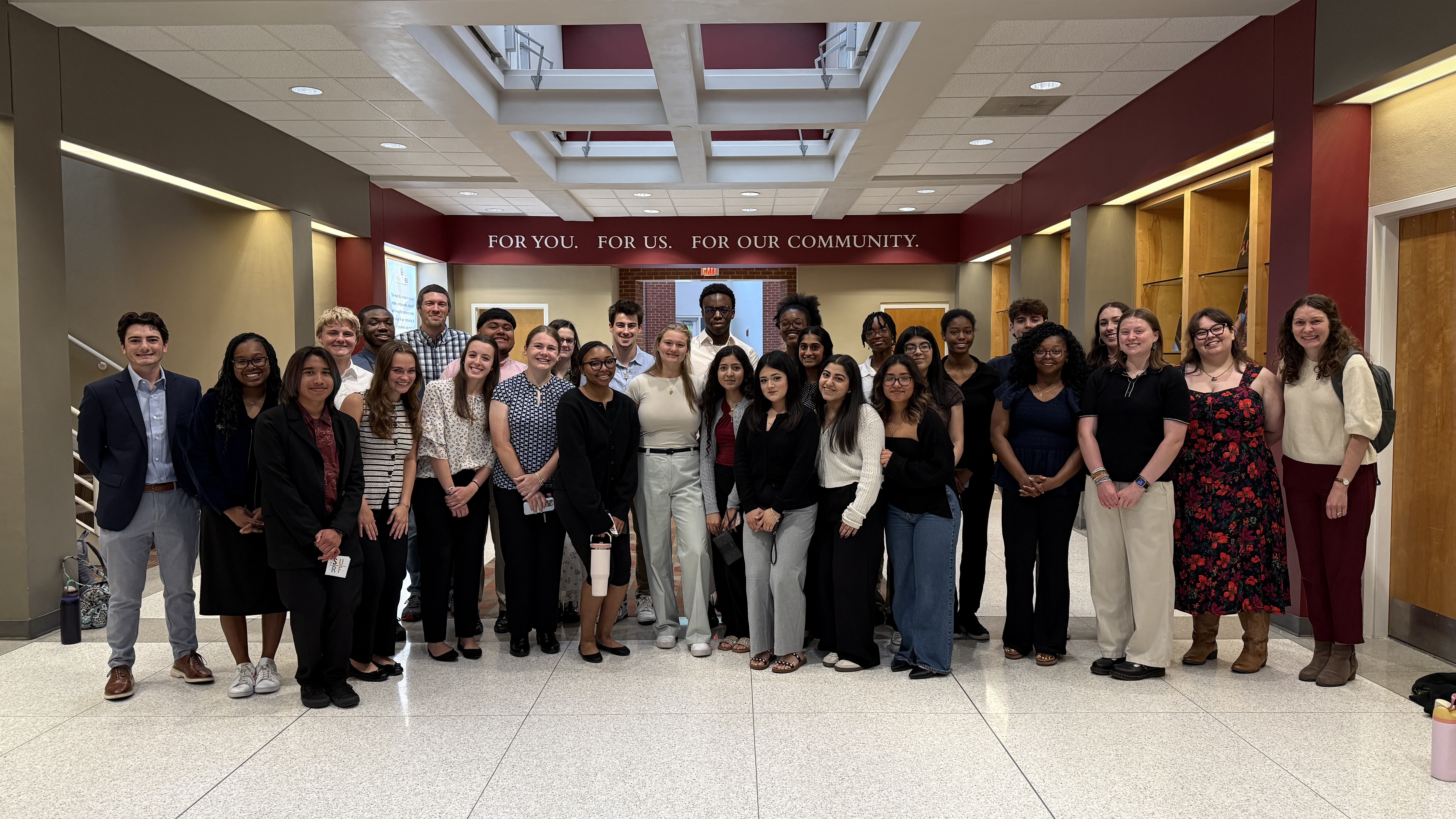 Mentors, students, and faculty from the WE RISE program in a group photo after their SURF presentations.