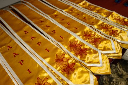 Gold graduation stoles embroidered with floral designs are displayed during the "Light the Way" Celebration.