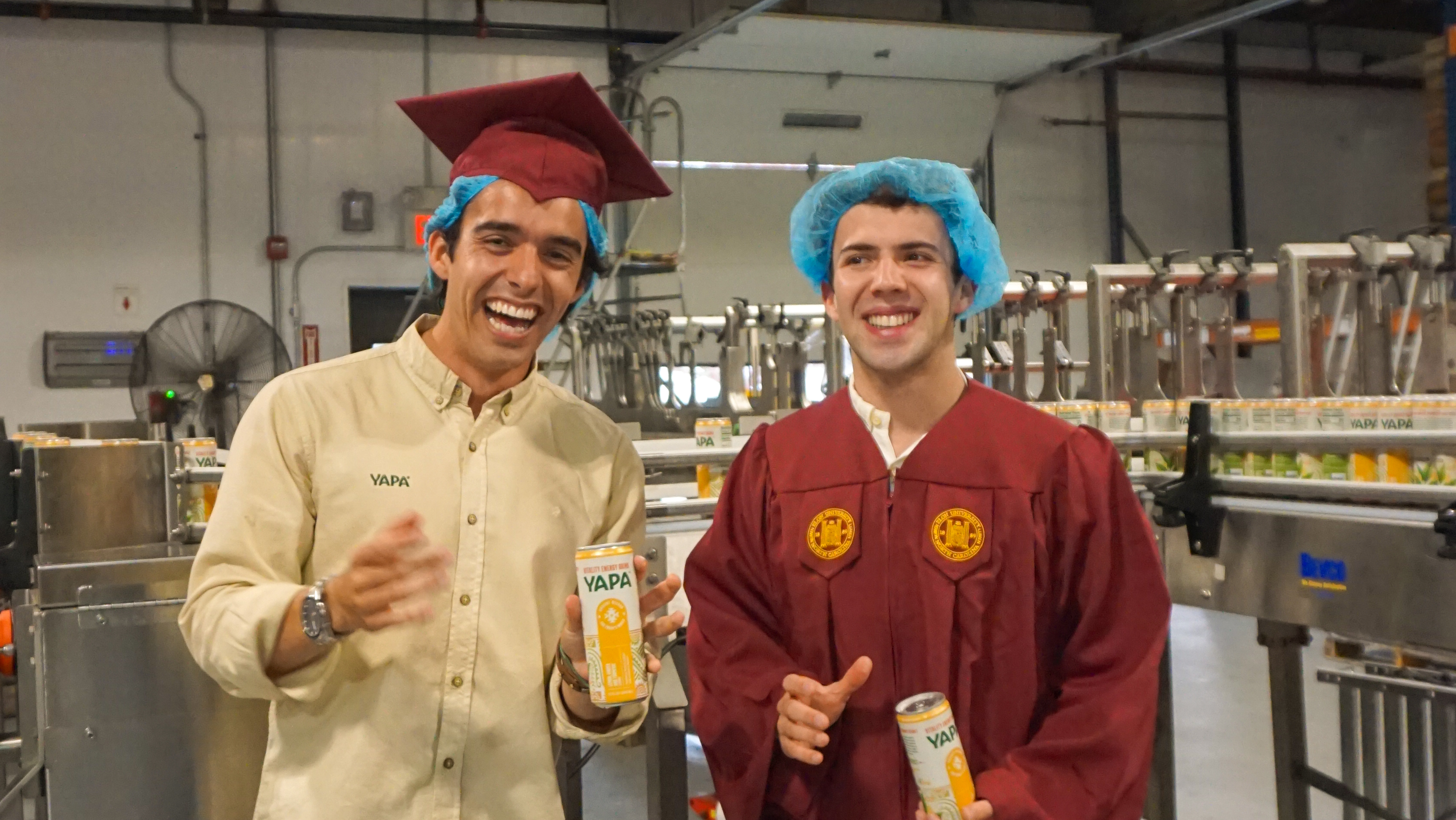 Vargas-Lopez and Chiriboga at the factory where YAPA is being produced in their ���ϲ����� graduation attire. 