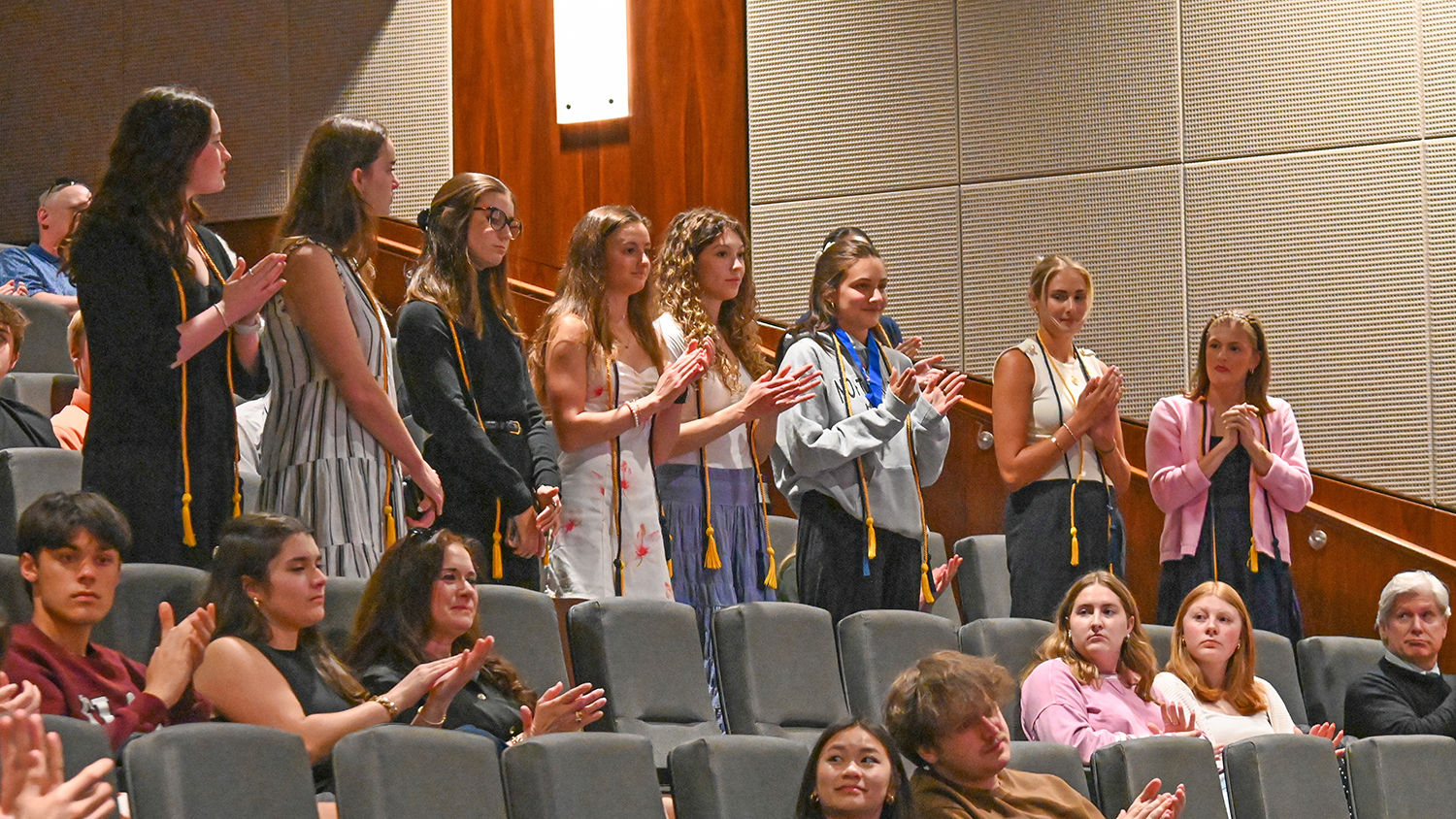 Kappa Tau Alpha inductees stand in Turner Theatre.