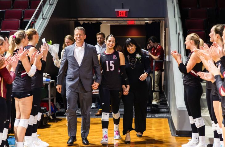 Simrin Carlsen G’26 poses with two family members on the court inside Schar Center.