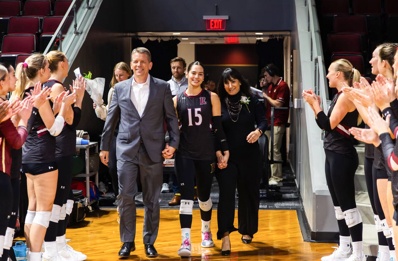 Simrin Carlsen G’26 poses with two family members on the court inside Schar Center.