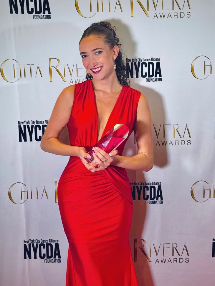 Helena Padial wearing a red dress and standing with her trophy at the Chita Rivera Awards on May 18.