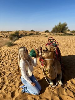 Kate Cooper with a camel on the Dubai trip with the Business Fellows