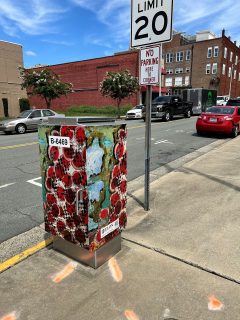 Signal box in Downtown Burlington covered with Elon student art