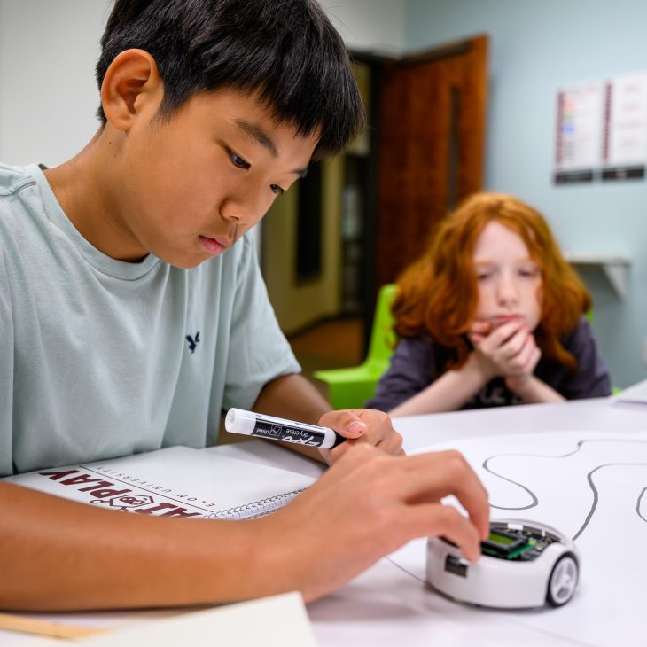 Middle school students participating in AI Play experiment with robot.
