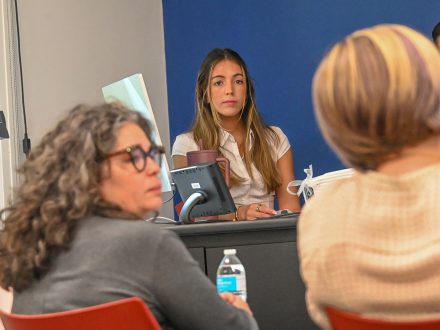 Alina Merchant stands at a computer in McEwen.
