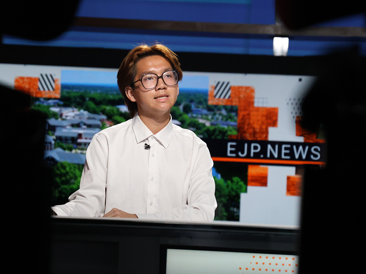 An EJP student sits at an anchor desk