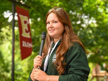 A female student holds a microphone